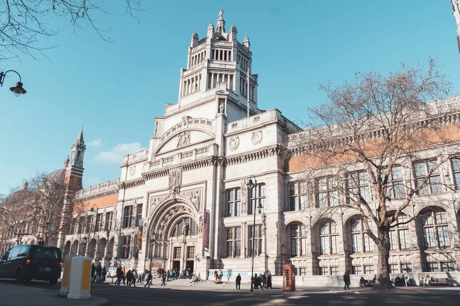 The front of the Victoria and Albert Museum on Cromwell Road under a blue sky.