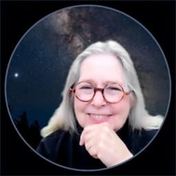 Elizabeth Power, founder of The Trauma Informed Academy, smiling with her chin resting on her hand against a starry night sky
